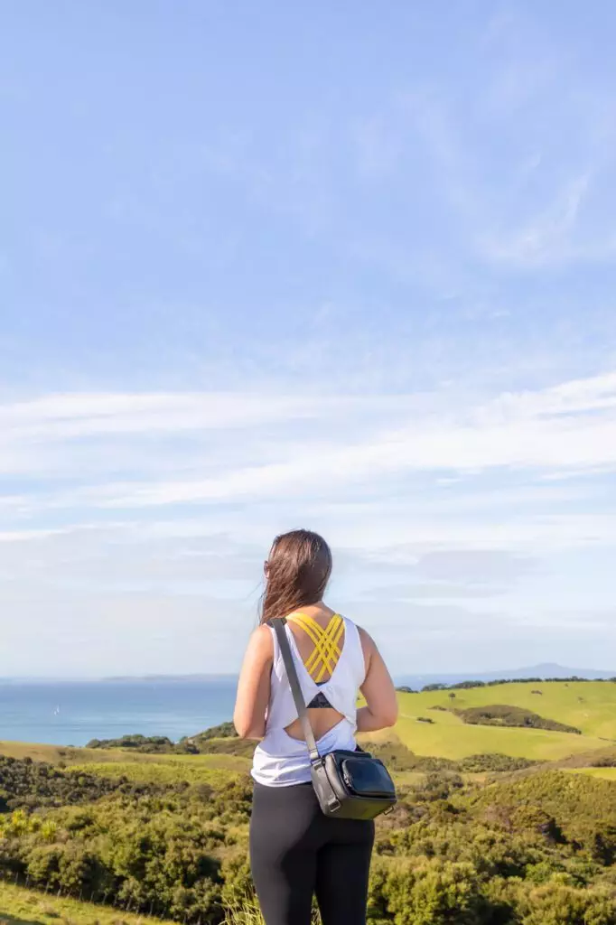 girl overlooking shakespeare park with status anxiety camera bag