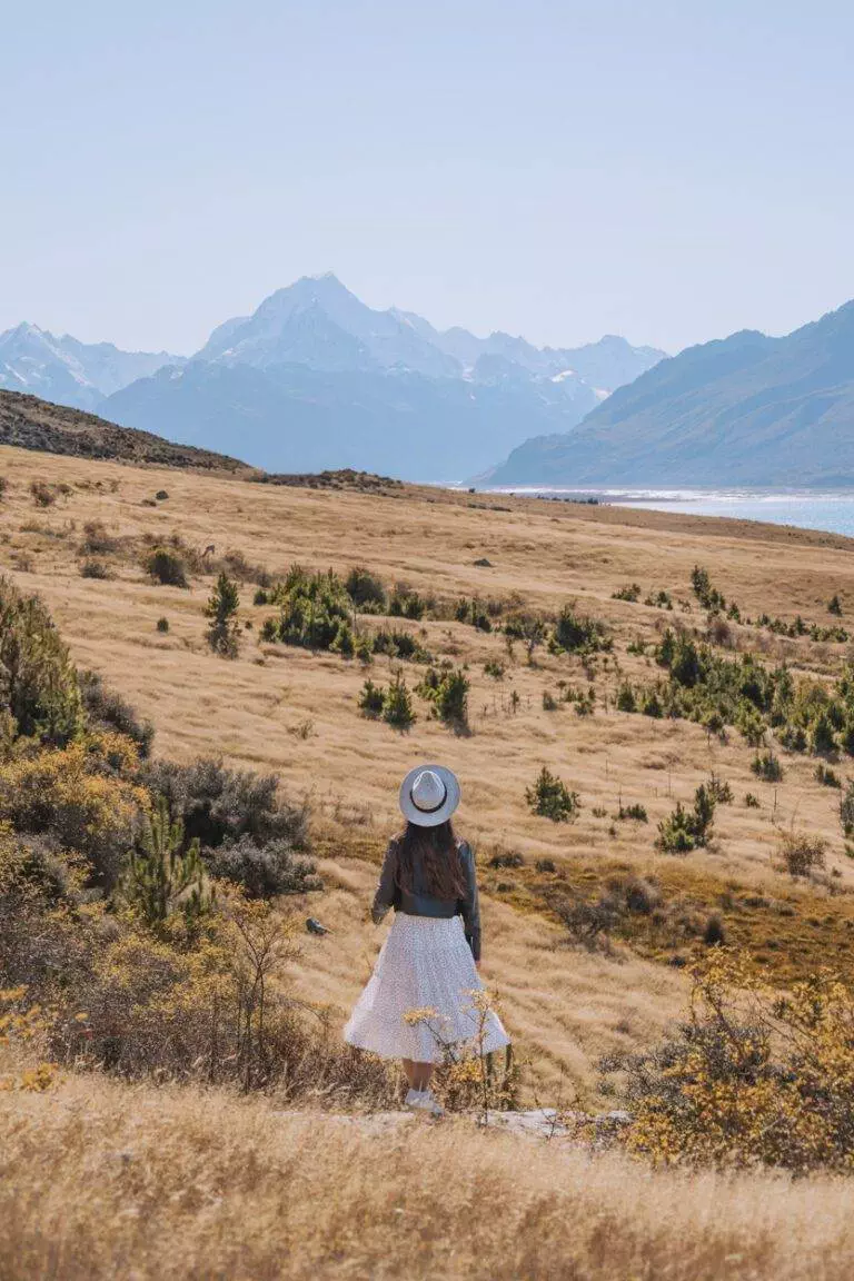 South Island landscape photography of woman standing in front of mount cook